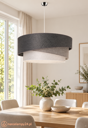 Nowoczesna lampa TRIO KOBO wyróżnia się trzema abażurami w odcieniach grafitu i szarości. Tkaninowy klosz miękko rozprasza światło, tworząc przytulną atmosferę w salonie lub sypialni.