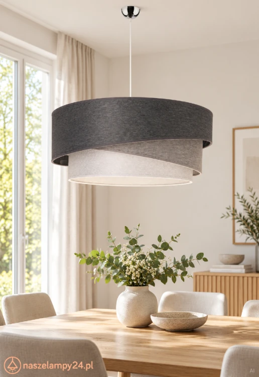 Nowoczesna lampa TRIO KOBO wyróżnia się trzema abażurami w odcieniach grafitu i szarości. Tkaninowy klosz miękko rozprasza światło, tworząc przytulną atmosferę w salonie lub sypialni.