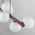 TK-Lighting ESTERA WOOD 10273: podłużna lampa wisząca z drewna w kolorze orzecha i 9 białymi szklanymi kloszami. Wymiary 28 × 117 × 125 cm. Do jadalni, salonu i nad kuchenną wyspę. Żarówki G9 LED są dostępne osobno.