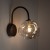 Lampa ścienna LAVA 11024 Brown TK-Lighting zachwyca organicznym szklanym kloszem i brązową oprawą. Do sypialni, salonu lub holu. Obsługuje 1×G9 LED maks. 8 W. Ściemnianie wymaga odpowiedniej żarówki i ściemniacza. Bez żarówki w zestawie.