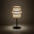 CALISTO TK-Lighting to lampka stołowa w stylu boho, która ozdobi salon lub sypialnię. Jutowy abażur wyróżnia się dekoracyjną formą, a czarny stelaż podkreśla jego naturalny kolor. 1×E27, maks. 15 W LED, IP20.