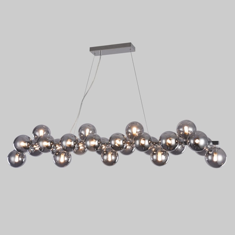 Lampa Cabella Italux 25xG9 to połączenie nowoczesnego designu i funkcjonalności. Chromowane wykończenie oraz szklane dymione kule tworzą wyjątkowy efekt świetlny w eleganckim wnętrzu.