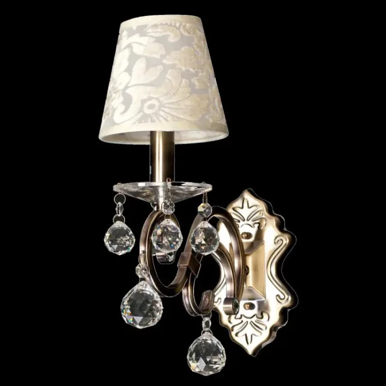 Elegancki kinkiet FLORENCE łączy klasyczną formę z glamour. Abażur ecru, metal w kolorze patyny i przezroczyste kryształy subtelnie rozpraszają światło, tworząc przytulną atmosferę w sypialni i salonie.