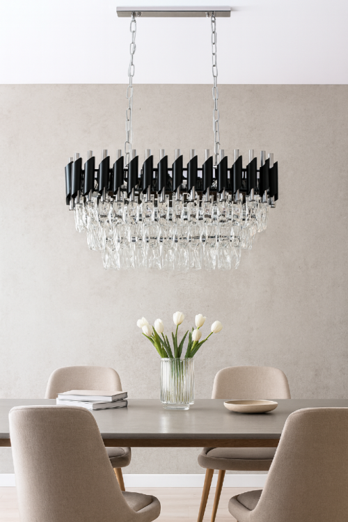 Żyrandol kryształowy TOLEDO 6xE27 czarny chrom to elegancka lampa wisząca w stylu glamour. Połączenie czerni, chromu i kryształów tworzy luksusowy efekt świetlny idealny nad stół w jadalni.