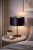 Czarna lampa stołowa CANNES 1xE14 to stylowy dodatek do salonu i sypialni. Atłasowy abażur z złotą folią ociepla światło, tworząc przytulną i elegancką atmosferę we wnętrzu.