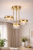 Nowoczesny plafon sufitowy LED w kolorze piaskowanego złota z dekoracyjnymi, przezroczystymi kloszami. Lampa z trzema punktami świetlnymi tworzy efektowną iluminację i doskonale pasuje do eleganckich wnętrz.