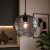 Nowoczesna lampa wisząca BRESCO PND-3033-1-BK-SG zachwyca połączeniem czerni i dymionego szkła. Dzięki oprawce E27 możesz zastosować żarówki LED lub klasyczne, tworząc idealne oświetlenie do każdego pomieszczenia.