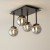 Lampa sufitowa TULIA 4xG9 czarna z dymionymi kloszami efektownie oświetli salon, jadalnię, sypialnię lub korytarz. Cztery szklane kule umieszczone na prętach o różnej długości tworzą ciekawą, przestrzenną kompozycję.
