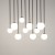 TULIA 10xG9 to nowoczesna lampa sufitowa z czarną, matową podsufitką i białymi kloszami ze szkła. Model o wymiarach 75 × 19 × 90 cm pasuje do przestronnych jadalni, wysokich salonów, antresoli i reprezentacyjnych holi.