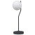 Lampka stołowa CARIMI Italux TB-3300-1-BK łączy grafitowy stalowy stelaż z białym kloszem w kształcie kuli. Ma 60 cm wysokości, 20 cm szerokości oraz oprawkę G9. Sprawdzi się na biurku, komodzie i stoliku nocnym.