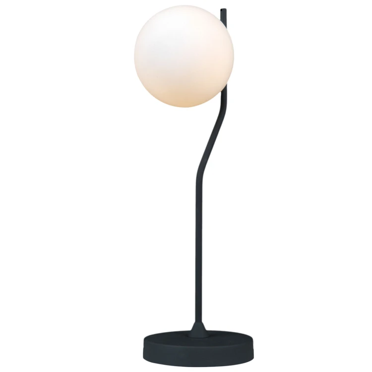 Nowoczesna lampka CARIMI TB-3300-1-BK z białym szklanym kloszem przyjemnie rozprasza światło. Grafitowy stelaż i okrągła podstawa tworzą minimalistyczną całość. Doskonała na stolik nocny, biurko, komodę lub konsolę.