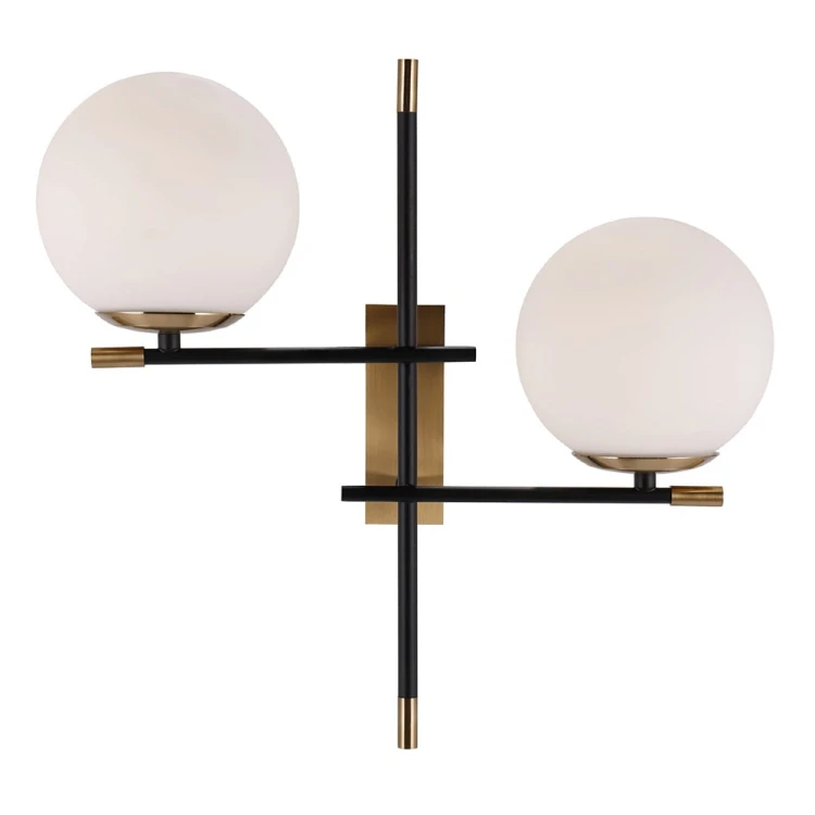 Kinkiet STELIA 2xE14 Italux to designerska lampa ścienna z białymi szklanymi kloszami. Czarne ramiona i detale w kolorze antycznego brązu tworzą elegancką dekorację nowoczesnego salonu, sypialni lub holu.