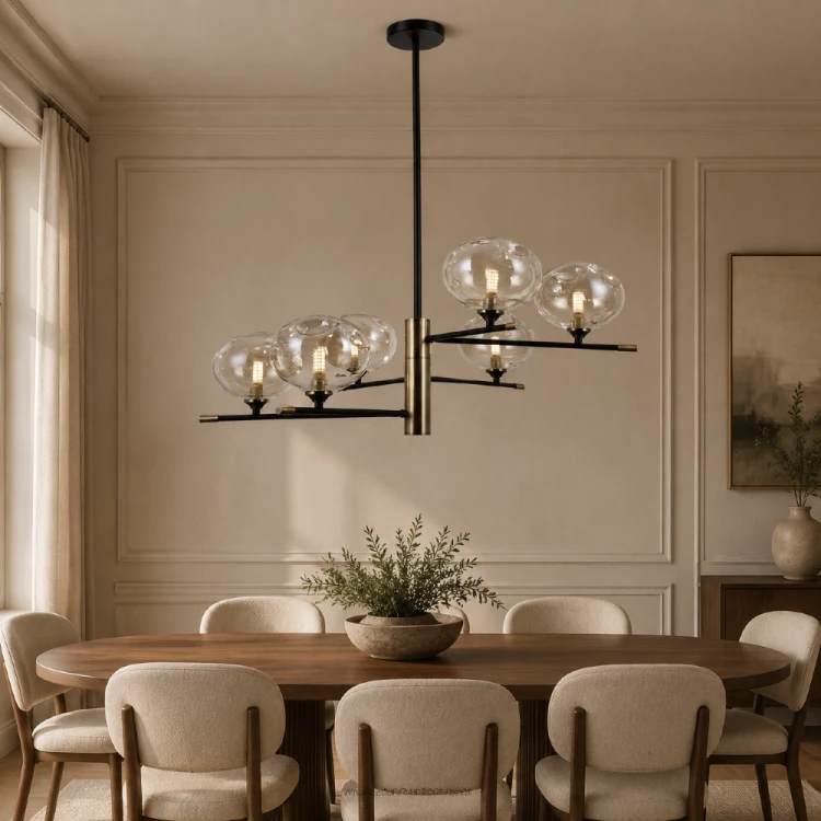 Czarno-złota lampa MESTA Italux 6xG9 wyróżnia się sześcioma bursztynowymi kloszami z nieregularnego szkła. Model o szerokości 72 cm pasuje nad stół oraz do salonu i jadalni urządzonej w stylu nowoczesnym lub modern classic.