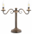 Lampa stołowa VELITA 2xE14 marki Lemir w kolorze patyny. Klasyczna stalowa konstrukcja, dwa ramiona i włącznik na przewodzie. Eleganckie oświetlenie na komodę, konsolę, biurko lub większy stolik pomocniczy.