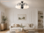 Lampa FRIDA 5xE27 to eleganckie oświetlenie z czarną, matową konstrukcją, chromowanymi detalami i białymi kloszami. Podział świecenia 3+2 pozwala dopasować intensywność światła do potrzeb domowników.