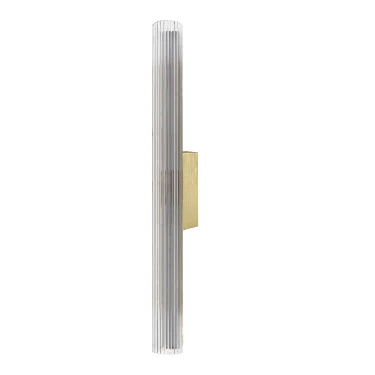 Kinkiet TRIVIA GOLD LED 11W w kolorze szczotkowanego złota. Ryflowany klosz i długość 60 cm tworzą elegancką oprawę przy lustrze. Strumień 930 lm, trzy barwy światła 2700K, 3000K i 4000K oraz ochrona IP44.