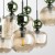 Efektowna lampa sufitowa SOPHIA 8xE14 z koniakowymi kloszami i zielonymi detalami. Prostokątna podsufitka 80 × 30 cm pozwala oświetlić duży stół, wyspę lub barek. Wysokość lampy wynosi do 170 cm.